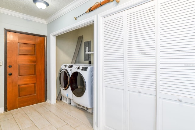 washroom featuring washer and clothes dryer, a textured ceiling, and ornamental molding