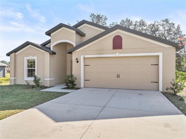 view of front facade featuring a front yard and a garage