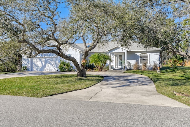 single story home with a garage and a front lawn