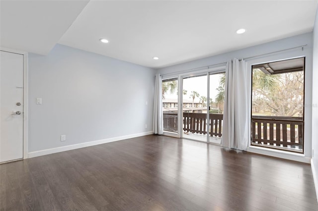 unfurnished room with dark wood-type flooring