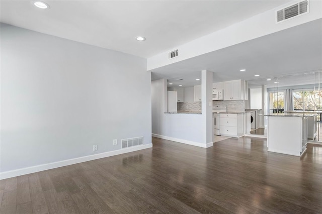 unfurnished living room featuring dark hardwood / wood-style flooring