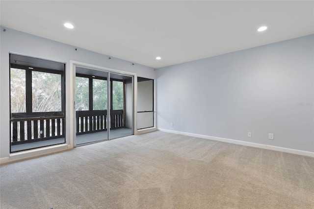 unfurnished room featuring light colored carpet