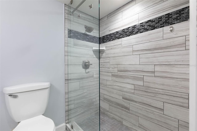 bathroom with tiled shower and toilet