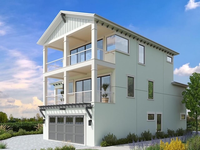 view of property exterior featuring a balcony and a garage