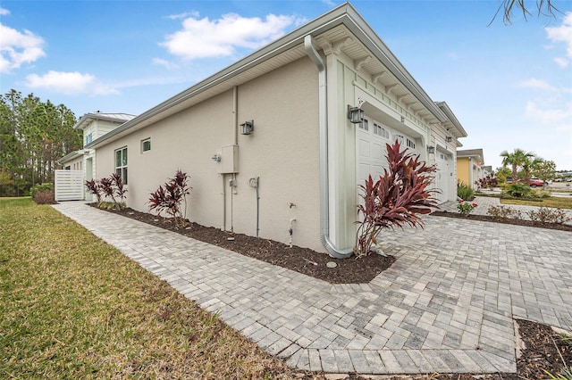 view of side of home featuring a yard and a garage