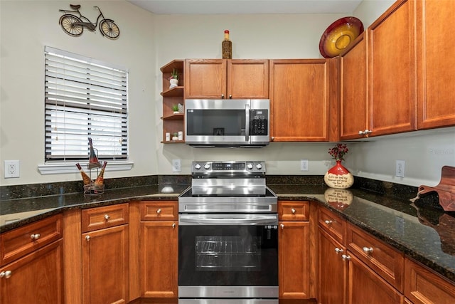 kitchen with stainless steel appliances and dark stone countertops