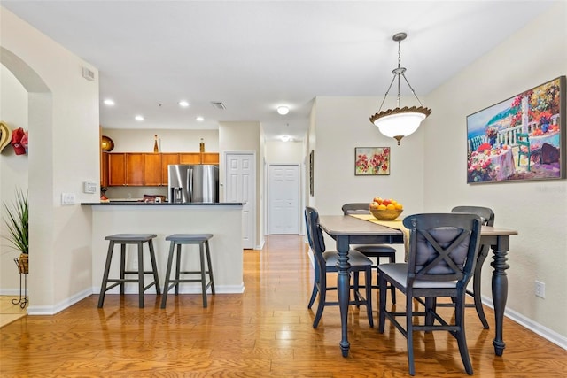 dining space featuring light wood-type flooring