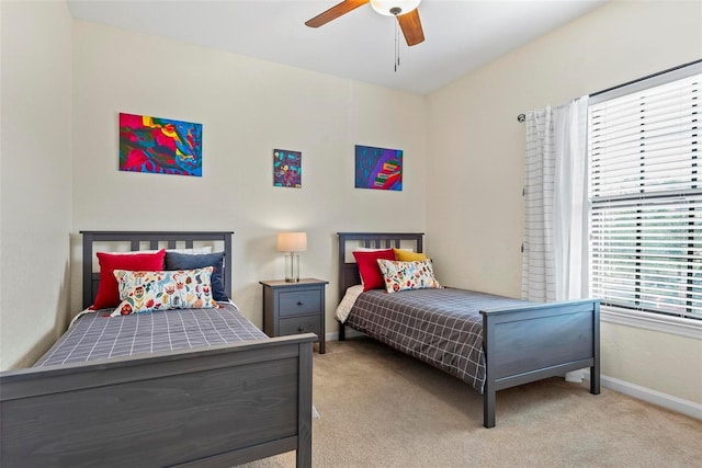 bedroom with multiple windows, light carpet, and ceiling fan