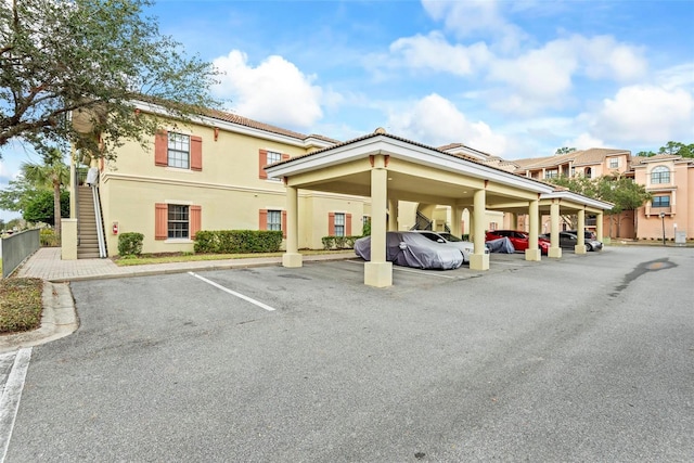 view of parking / parking lot featuring a carport