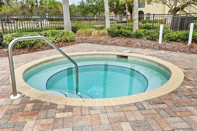 view of swimming pool with an in ground hot tub