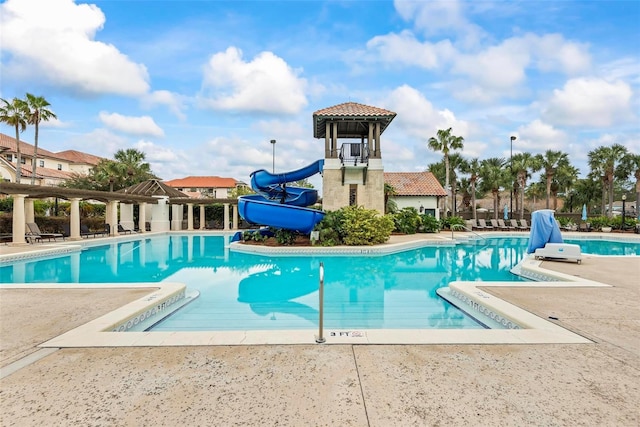 view of pool featuring a patio area and a water slide