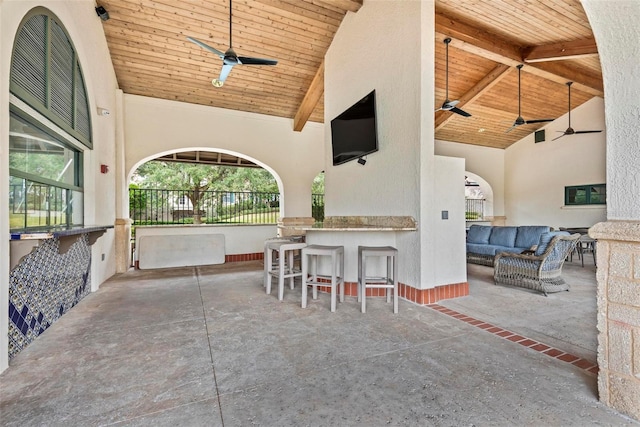 view of patio / terrace with outdoor lounge area, ceiling fan, and exterior bar