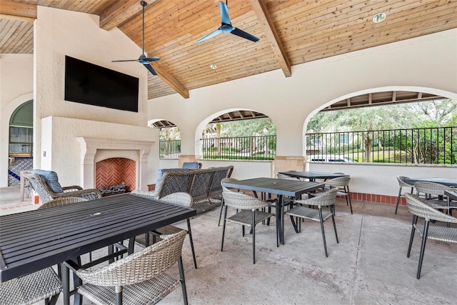 view of patio featuring an outdoor living space with a fireplace and ceiling fan