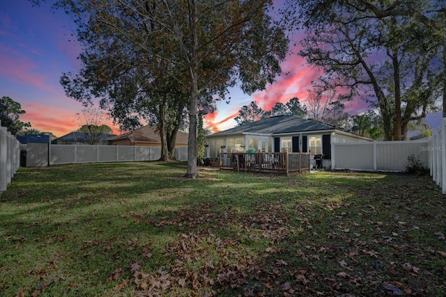 yard at dusk with a wooden deck