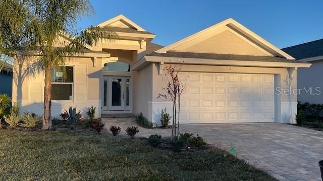 view of front facade featuring a front yard and a garage