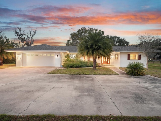 view of front of house with a garage and a lawn