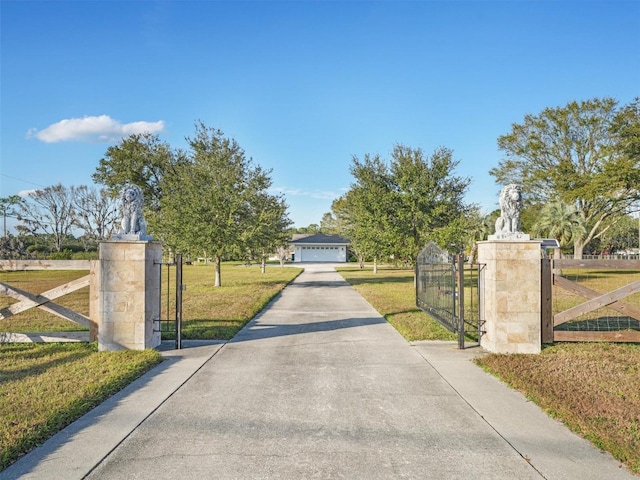 view of gate featuring a yard