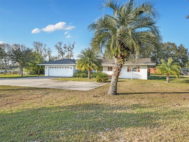 view of front of property with a garage and a front yard