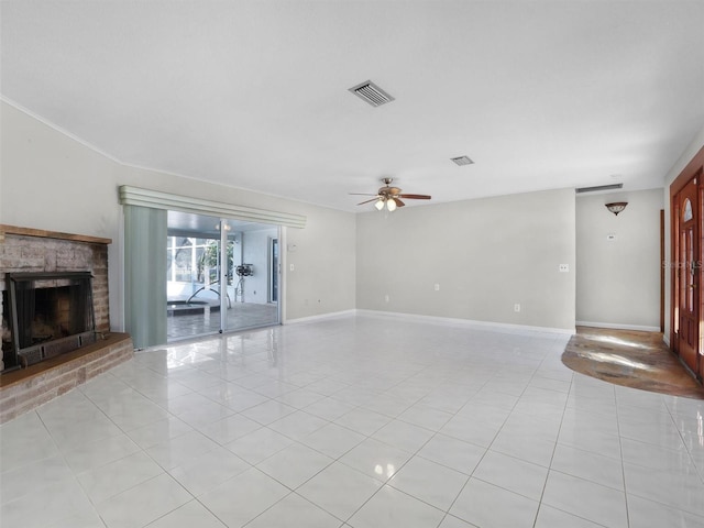 unfurnished living room with ceiling fan, light tile patterned flooring, and a fireplace