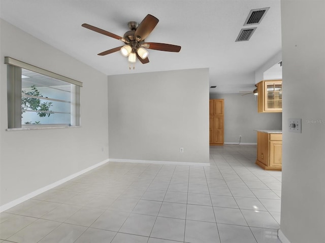 tiled empty room with ceiling fan