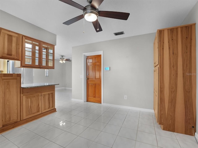 interior space featuring ceiling fan and light tile patterned flooring