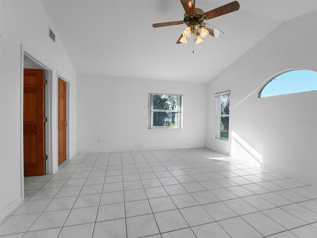 tiled spare room featuring ceiling fan and vaulted ceiling