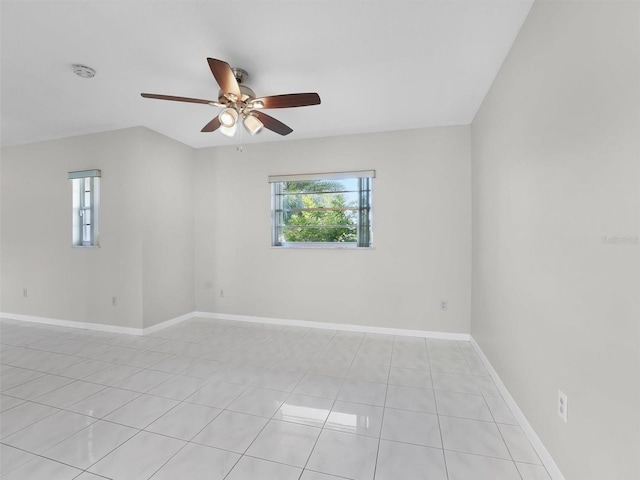 tiled spare room with ceiling fan