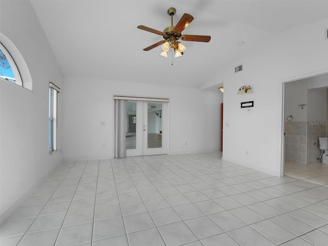 unfurnished room with ceiling fan, light tile patterned floors, and vaulted ceiling