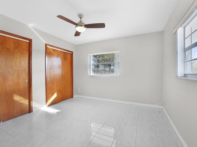 unfurnished bedroom featuring ceiling fan and light tile patterned floors