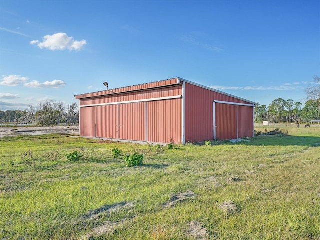 view of outbuilding featuring a yard