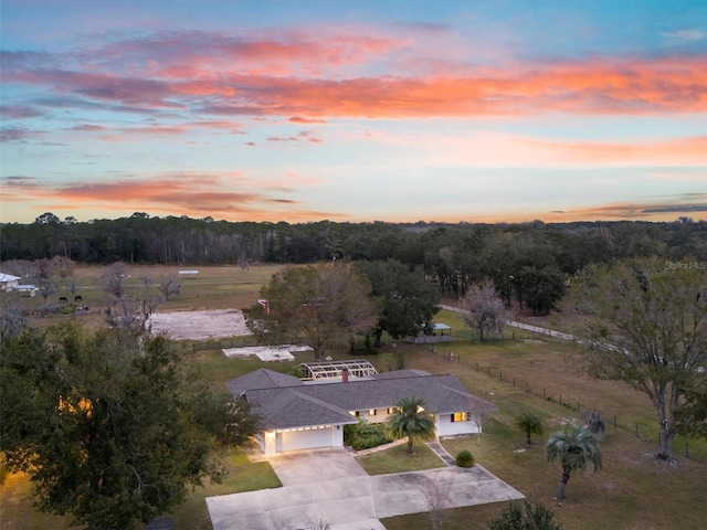 aerial view at dusk featuring a rural view