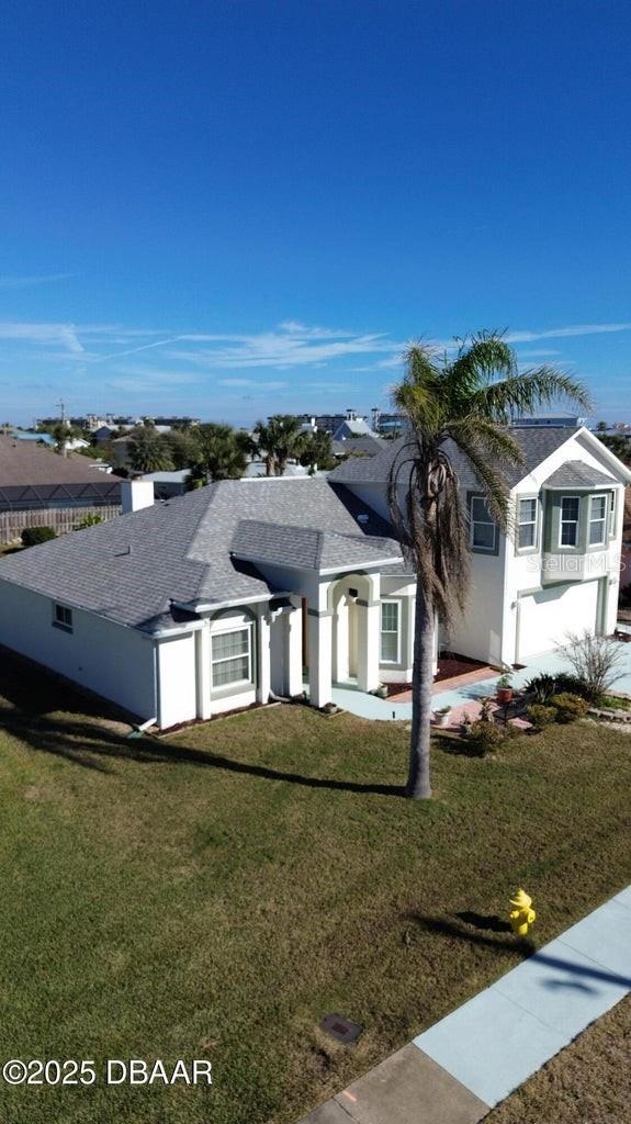 view of front of property featuring a garage and a front lawn