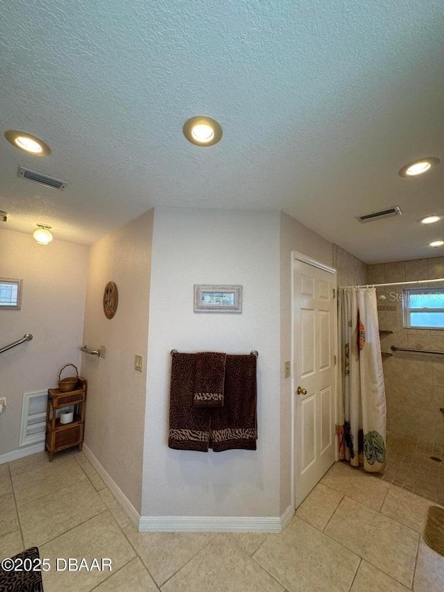 bathroom featuring tile patterned floors and a shower with curtain