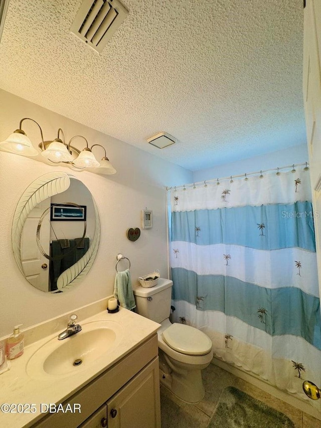 bathroom featuring a textured ceiling, vanity, tile patterned flooring, toilet, and curtained shower