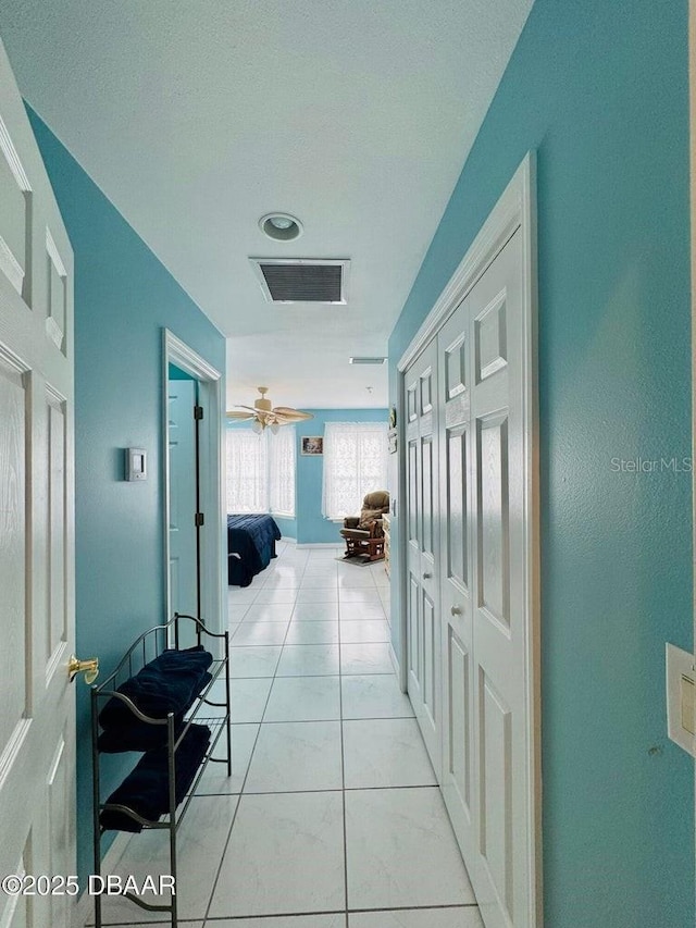 hallway with light tile patterned flooring