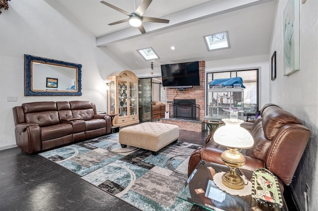 living room with a brick fireplace, lofted ceiling with skylight, and ceiling fan