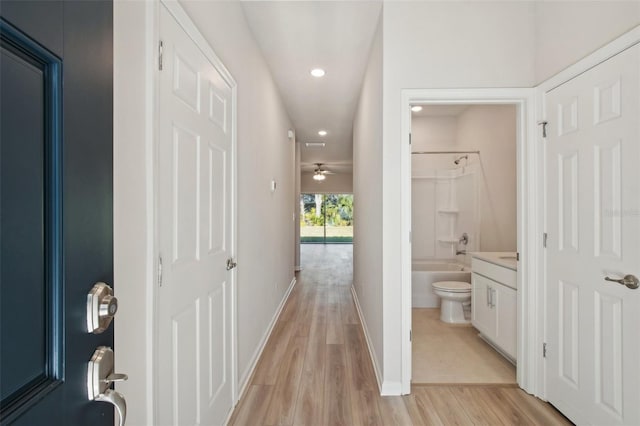 corridor with light wood-type flooring