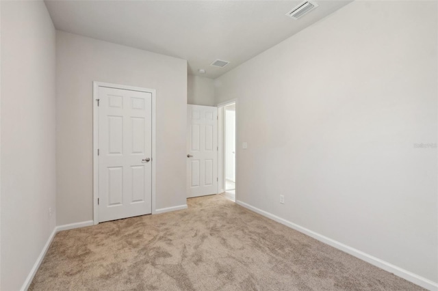 unfurnished bedroom with light colored carpet