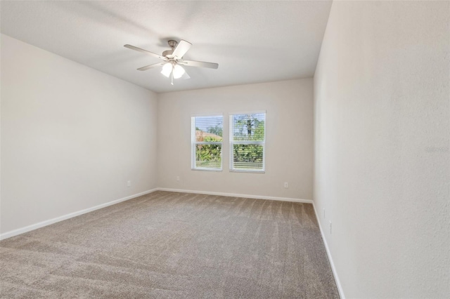 unfurnished room with ceiling fan and carpet