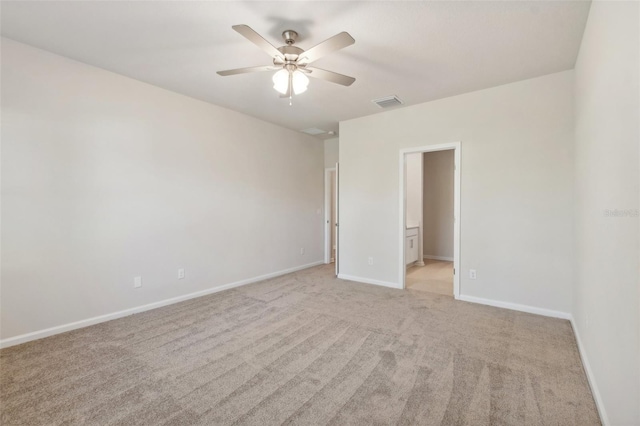 carpeted spare room with ceiling fan