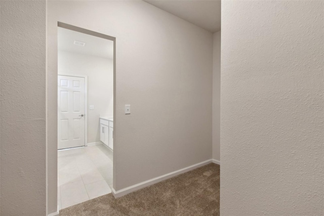 hall featuring light tile patterned flooring