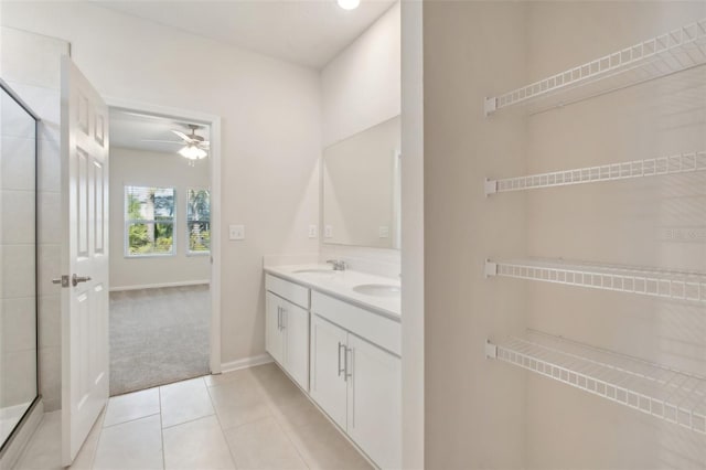 bathroom featuring tile patterned floors, ceiling fan, vanity, and an enclosed shower