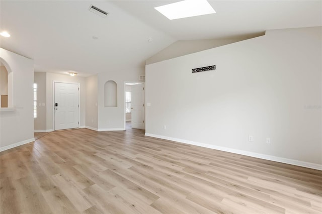 unfurnished living room with lofted ceiling with skylight and light hardwood / wood-style flooring