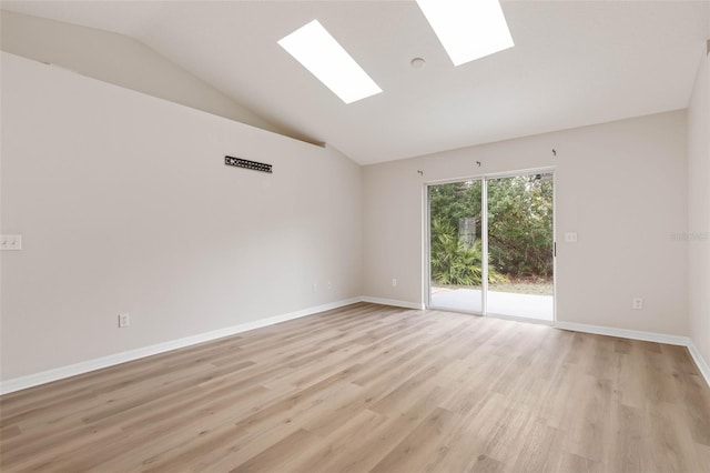 unfurnished room featuring light wood-type flooring and vaulted ceiling with skylight