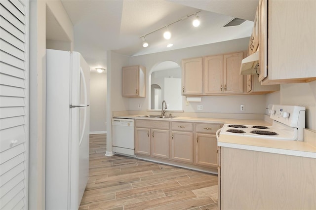 kitchen with sink, white appliances, and light brown cabinetry