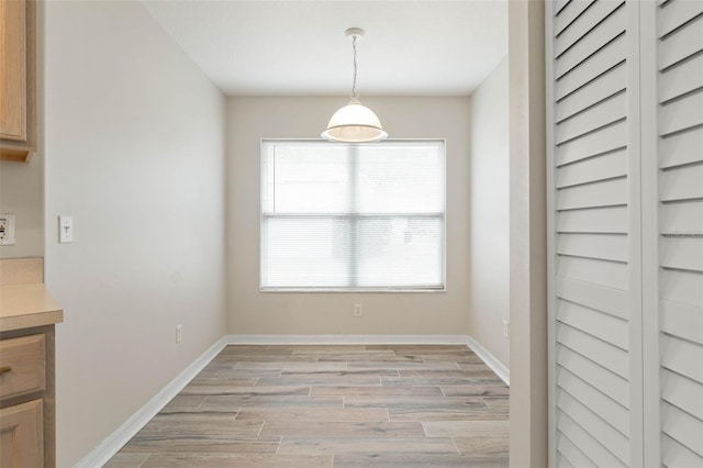 unfurnished dining area featuring plenty of natural light