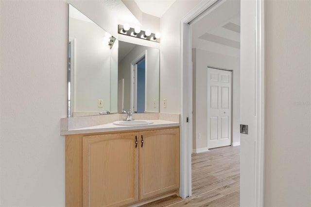 bathroom with vanity and hardwood / wood-style flooring