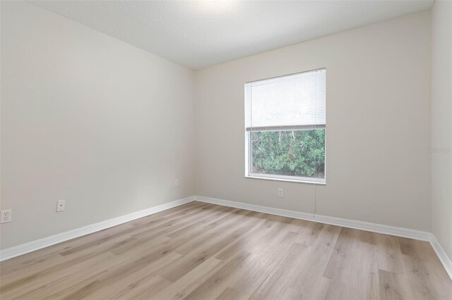 spare room featuring light hardwood / wood-style flooring