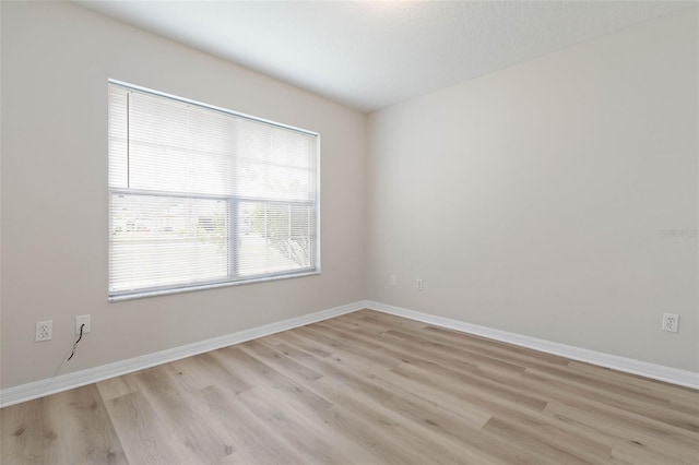 spare room with light hardwood / wood-style floors