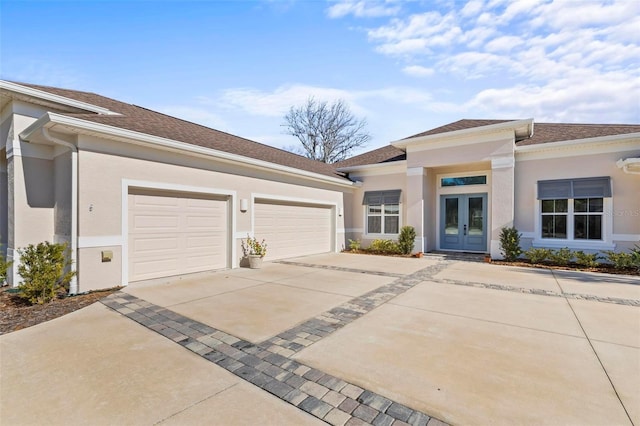 view of front of property featuring french doors and a garage